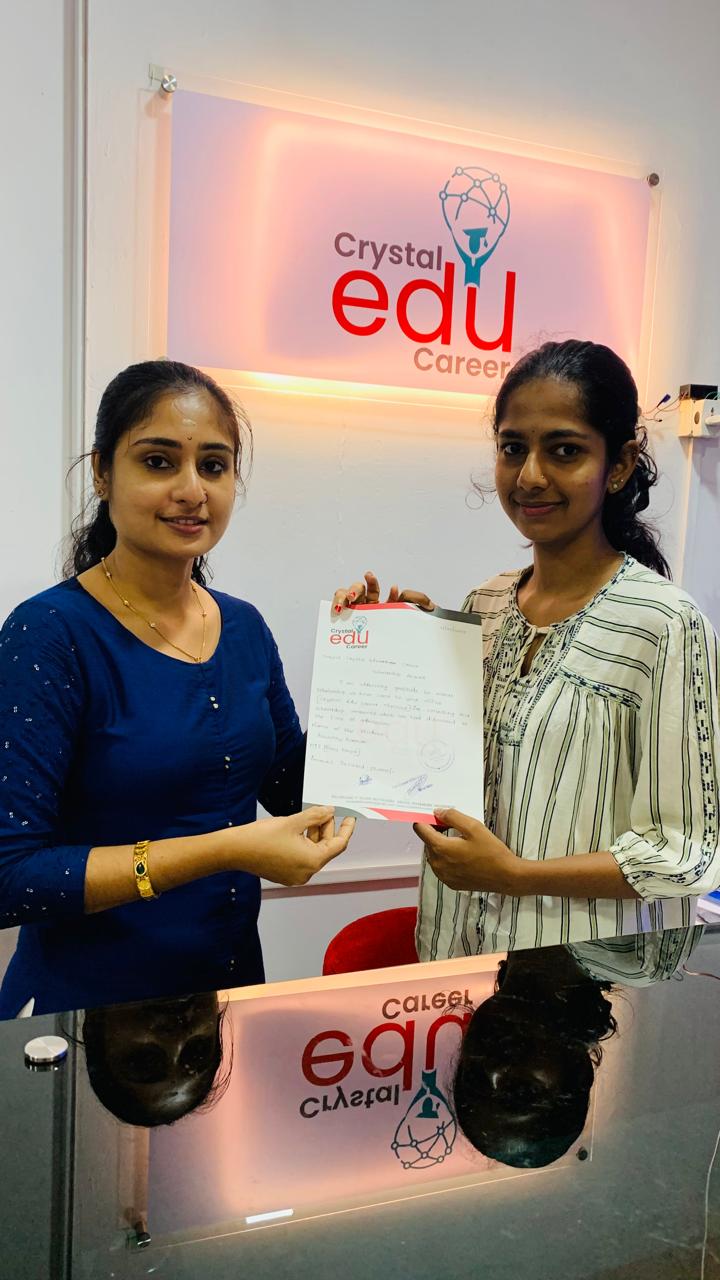 Student receiving a milestone completion document at the Crystal EDU Career office