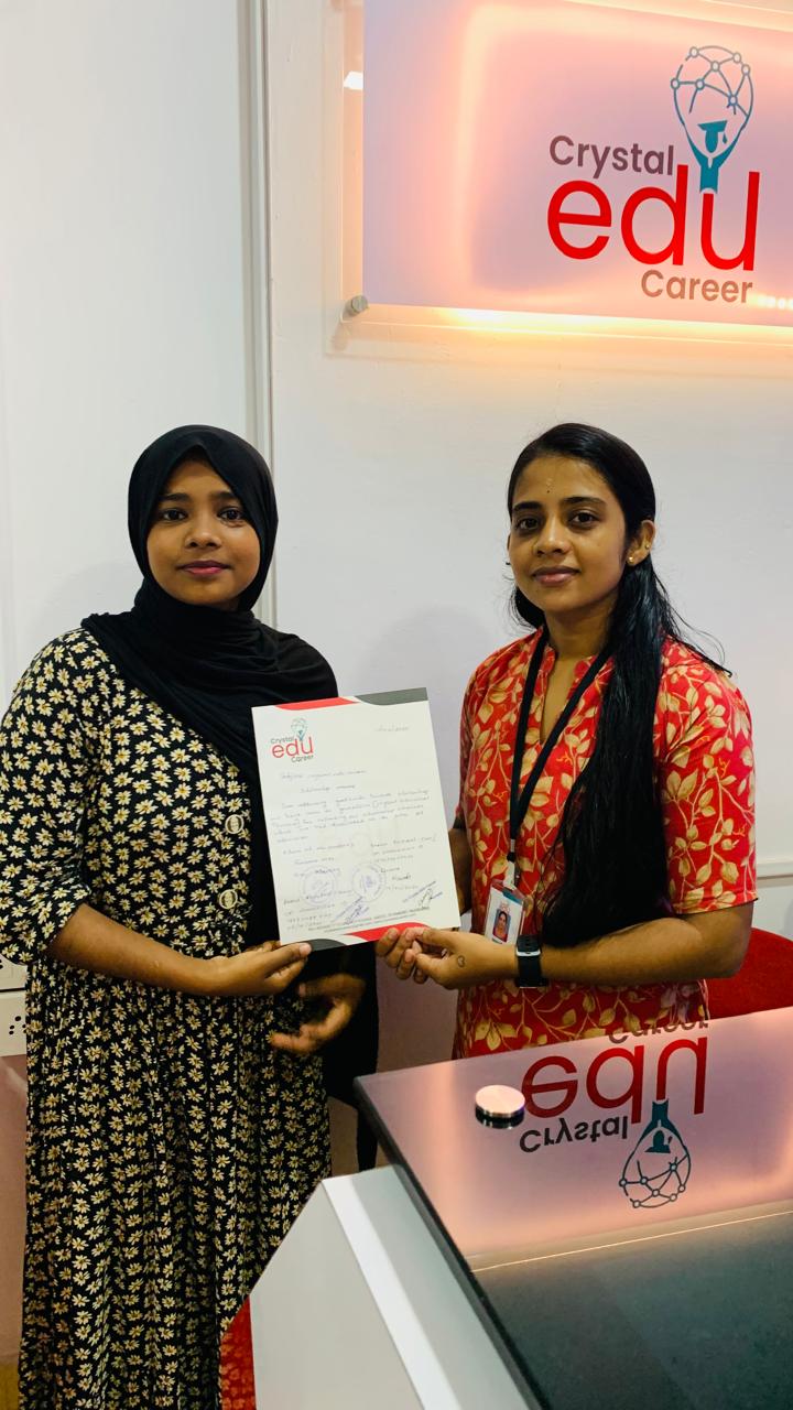 Student displaying her completed milestone document with a Crystal EDU Career counsellor